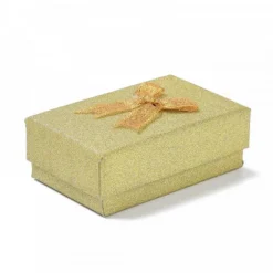emballage carton or avec des paillettes décoratives pour un anniversaire
